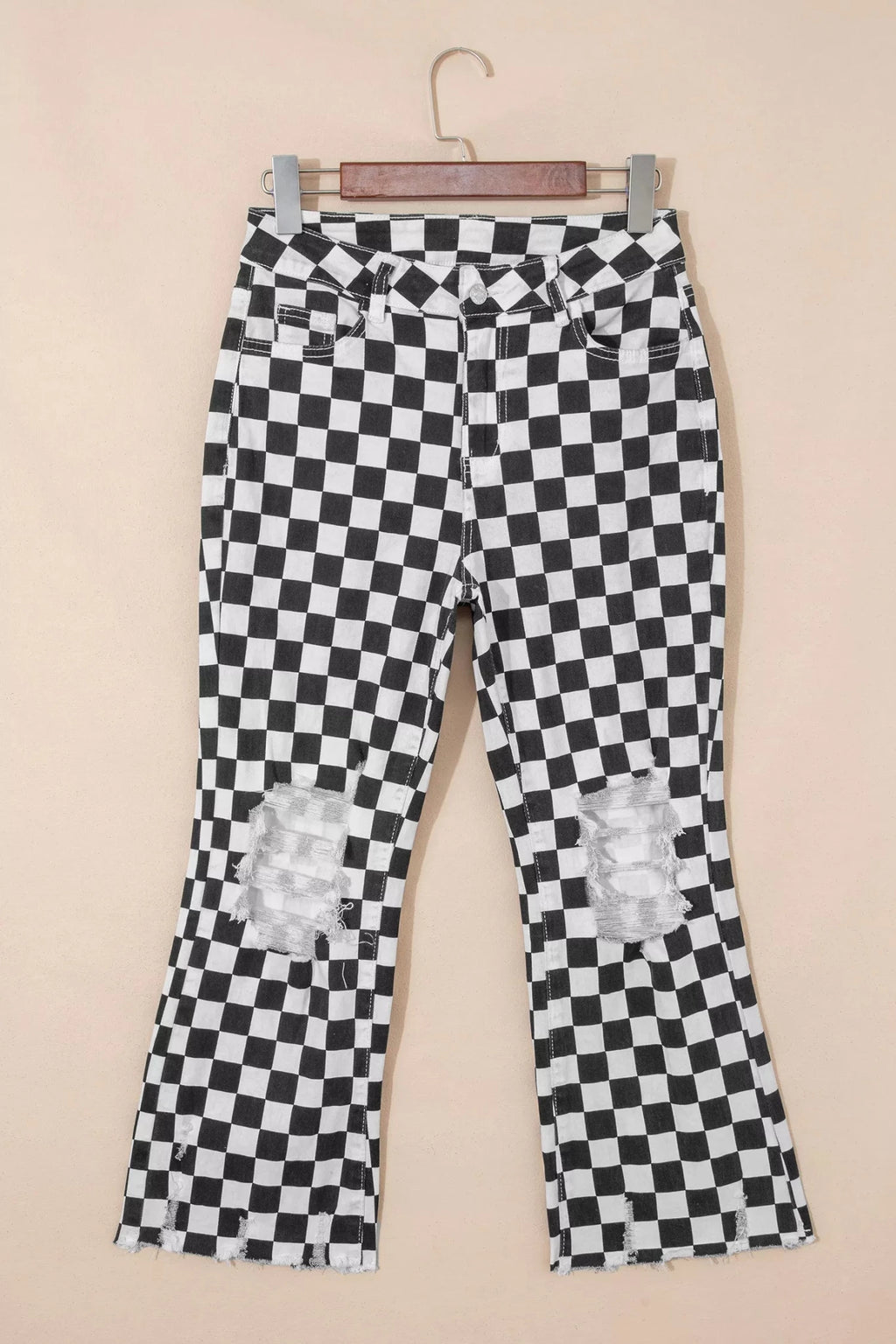 Women's checkerboard print distressed raw edge cropped jeans from Trendsi, featuring a trendy pattern and frayed hem detail.