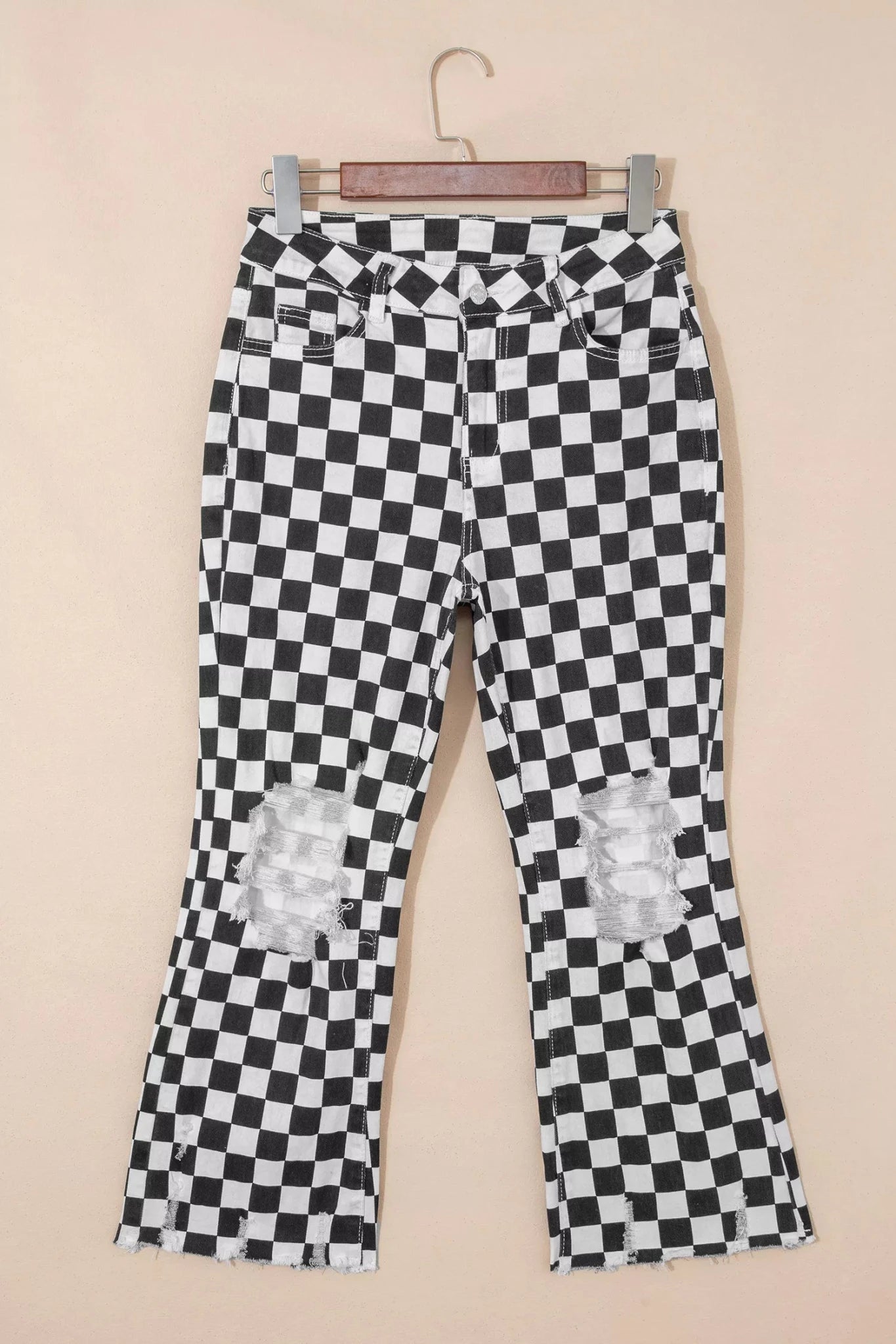 Women's checkerboard print distressed raw edge cropped jeans from Trendsi, featuring a trendy pattern and frayed hem detail.