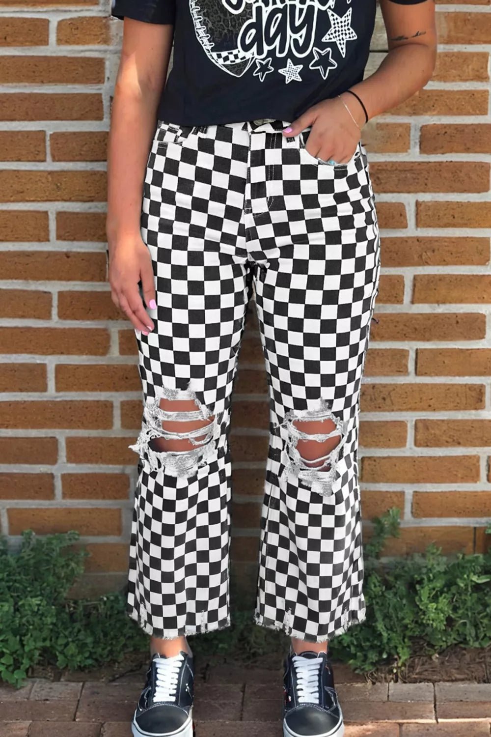 Women's checkerboard print distressed raw edge cropped jeans by Trendsi, featuring a fashionable checkerboard pattern and raw hem detail.