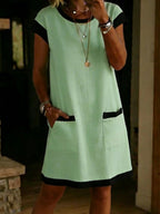 Women's color-block T-shirt mini dress with pocket and straight cut by FitiqueFit, casualwear style, shown in vibrant fabric.