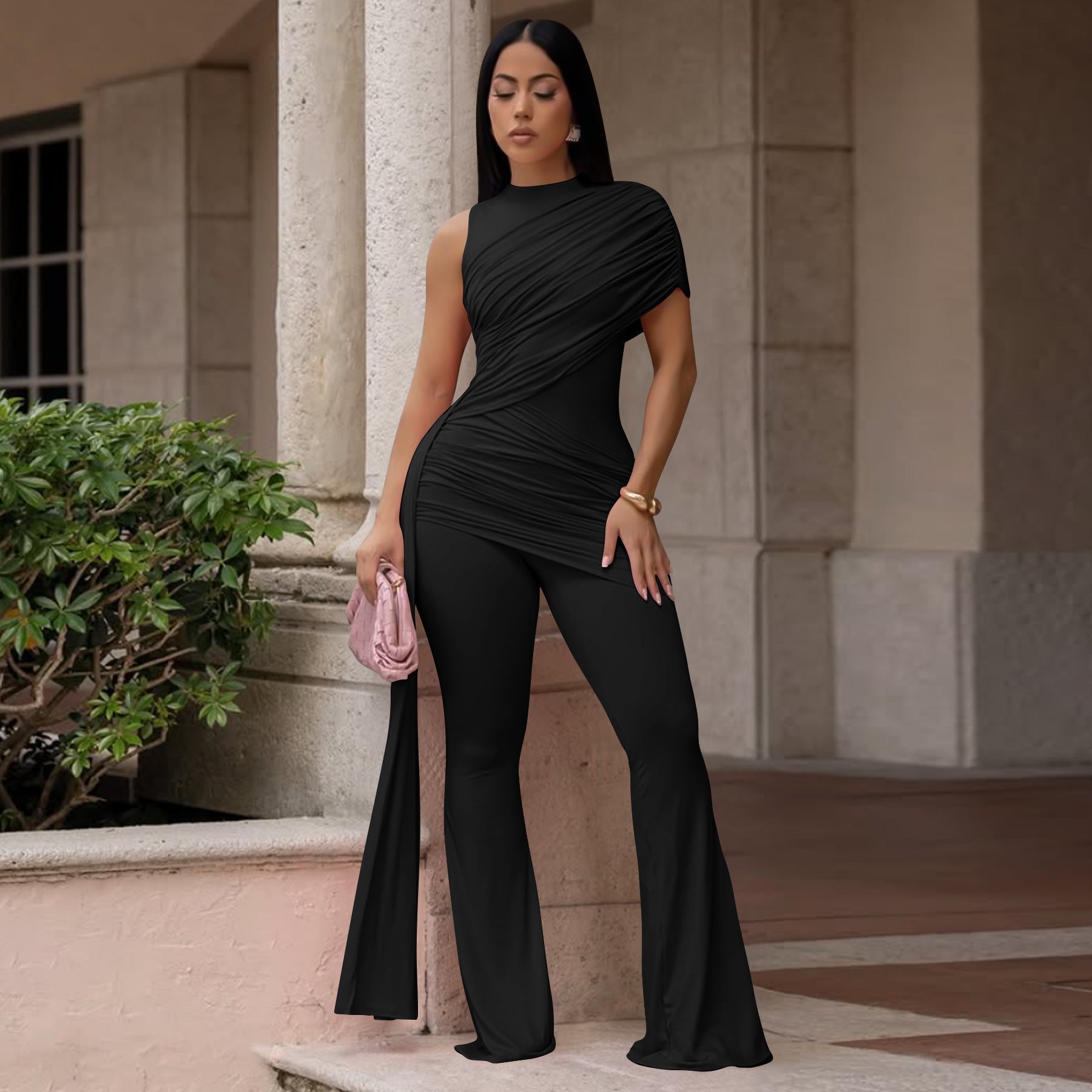 Women's casual FitiqueFit crew-neck pleated ribbon flare jumpsuit displayed on a model, showcasing its stylish design and relaxed fit.