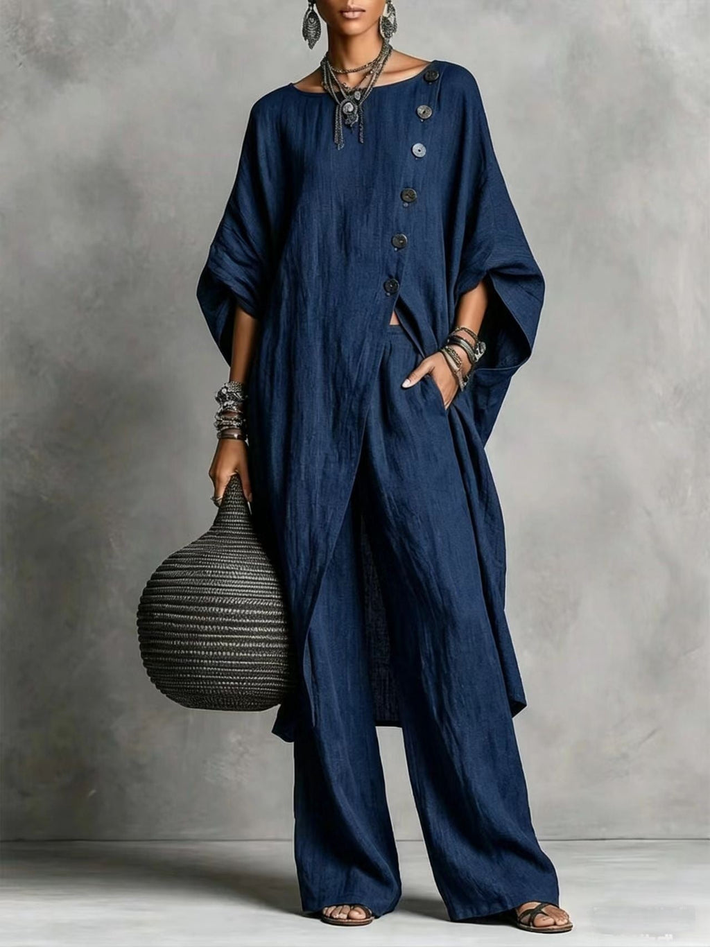 Women's casualwear set by FitiqueFit featuring a drop shoulder three-quarter sleeve irregular shirt and matching pants.