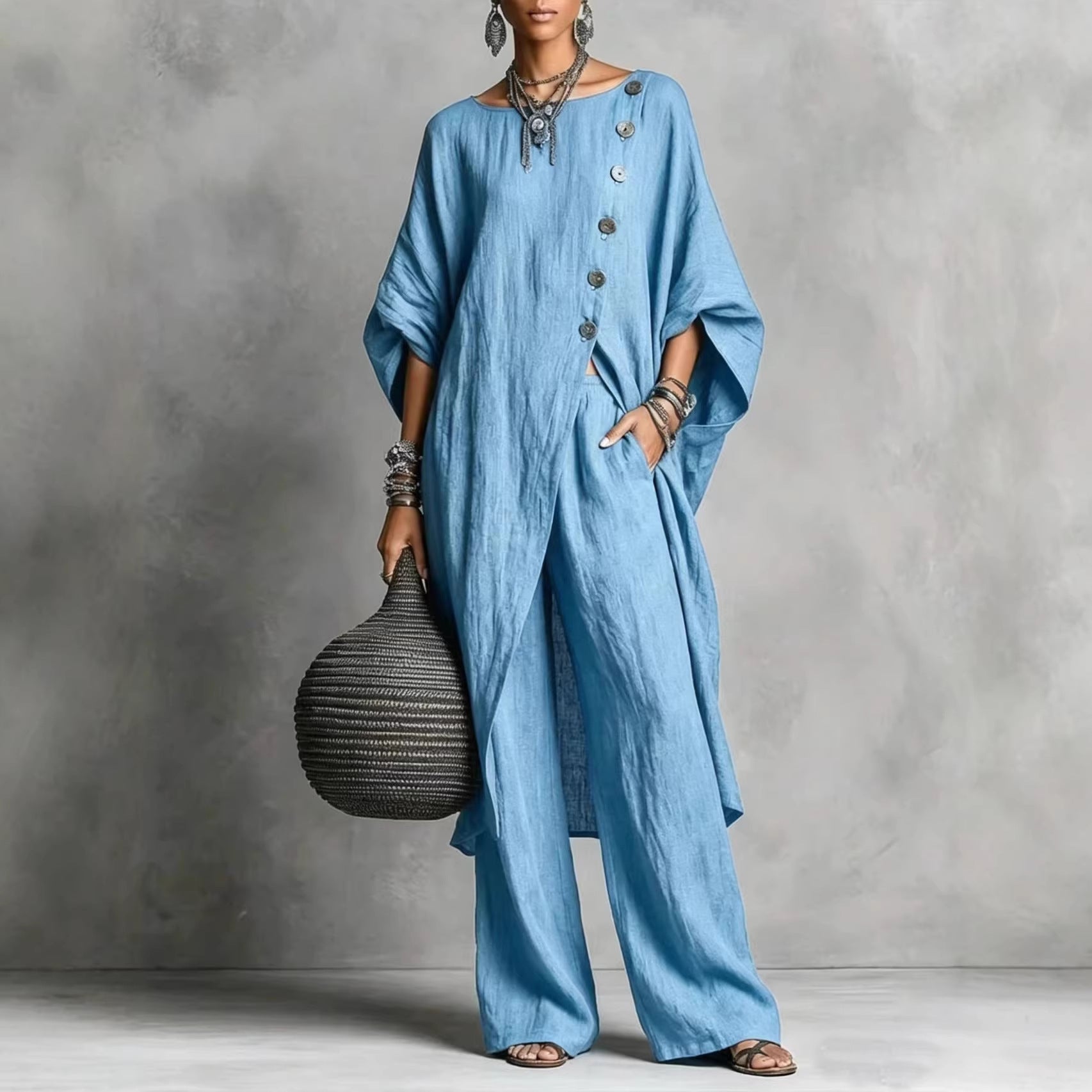Women's casualwear set by FitiqueFit featuring a drop shoulder three-quarter sleeve irregular shirt and matching pants.