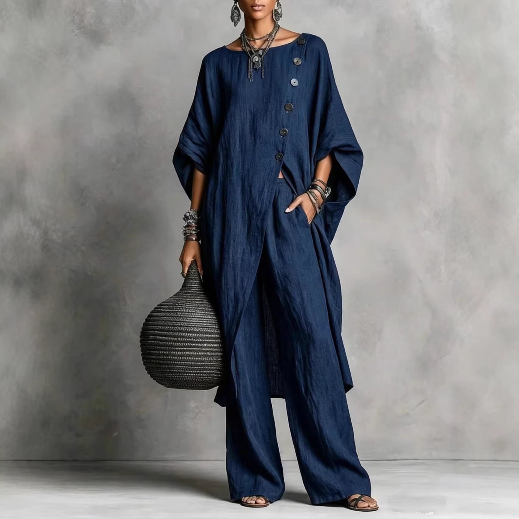 Women's casualwear set by FitiqueFit featuring a drop shoulder three-quarter sleeve irregular shirt and matching pants.