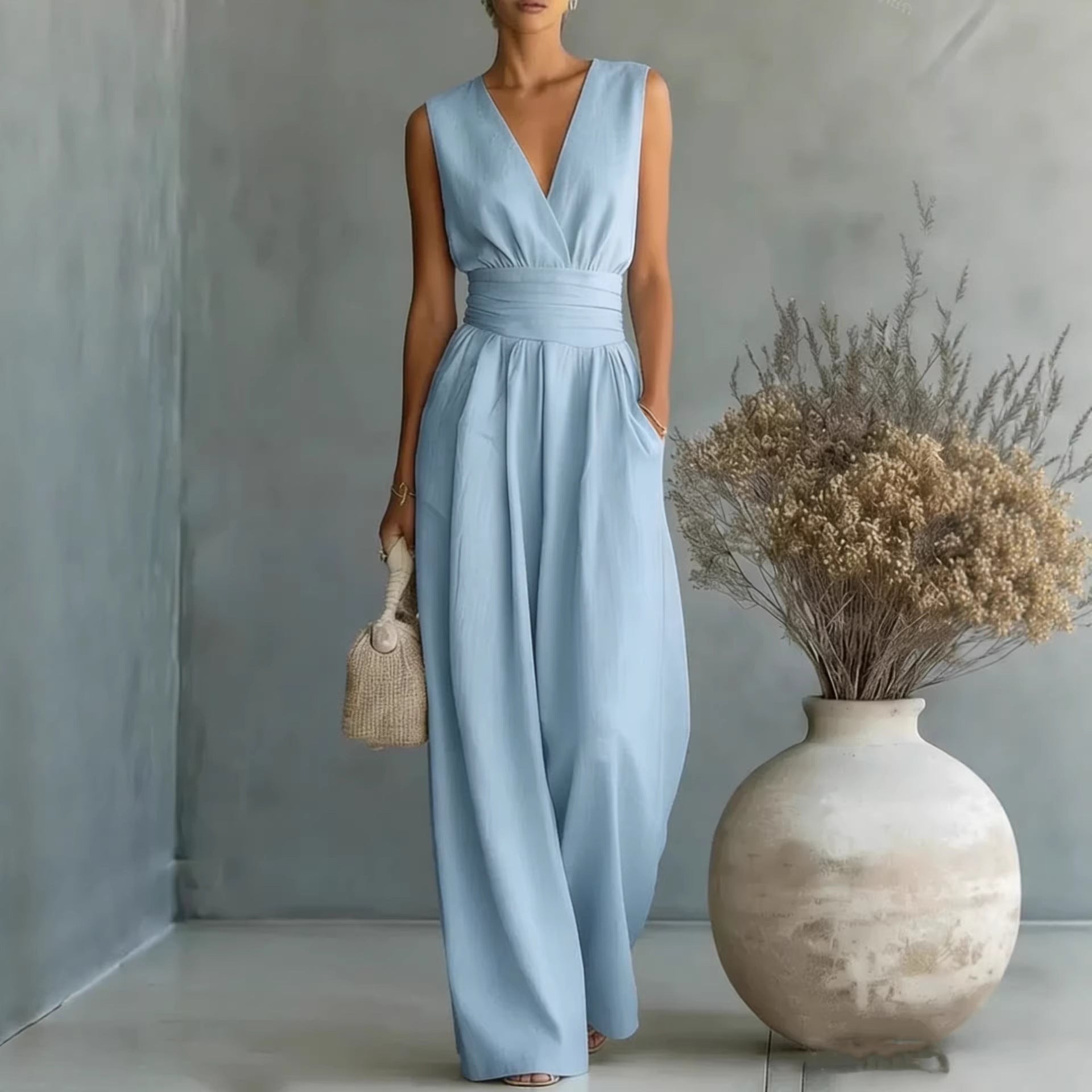 Women's elegant sleeveless V-neck jumpsuit with waist cinching and straight leg design, casualwear by Plush Fashion Hub.
