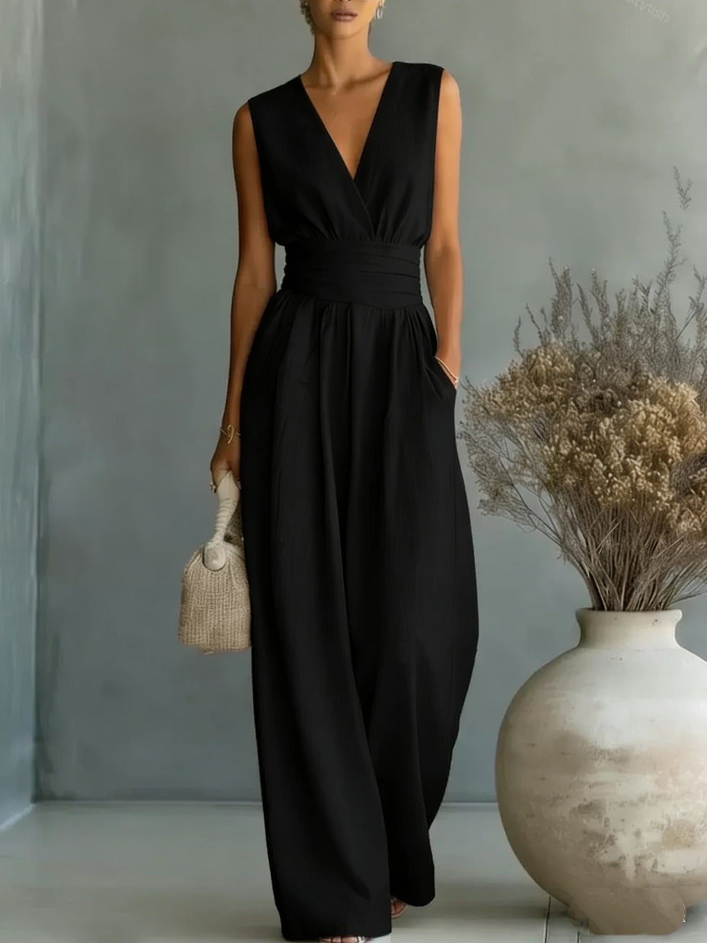 Women's elegant sleeveless V-neck jumpsuit with waist cinching and straight-leg design, casualwear by Plush Fashion Hub.