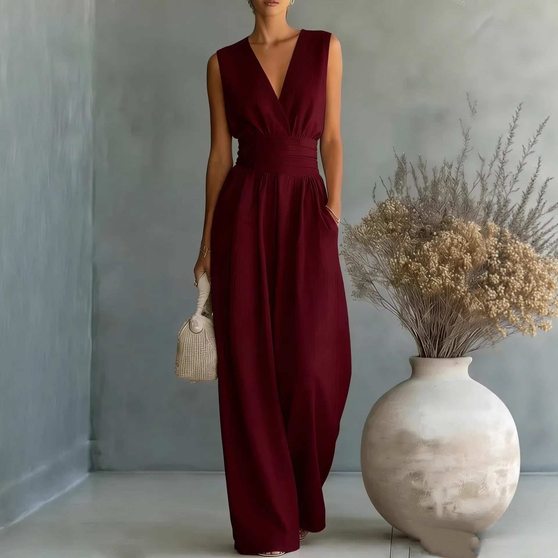 Elegant women's V-neck sleeveless jumpsuit with a waist-cinching fit and straight-leg design, ideal for casualwear by Plush Fashion Hub.