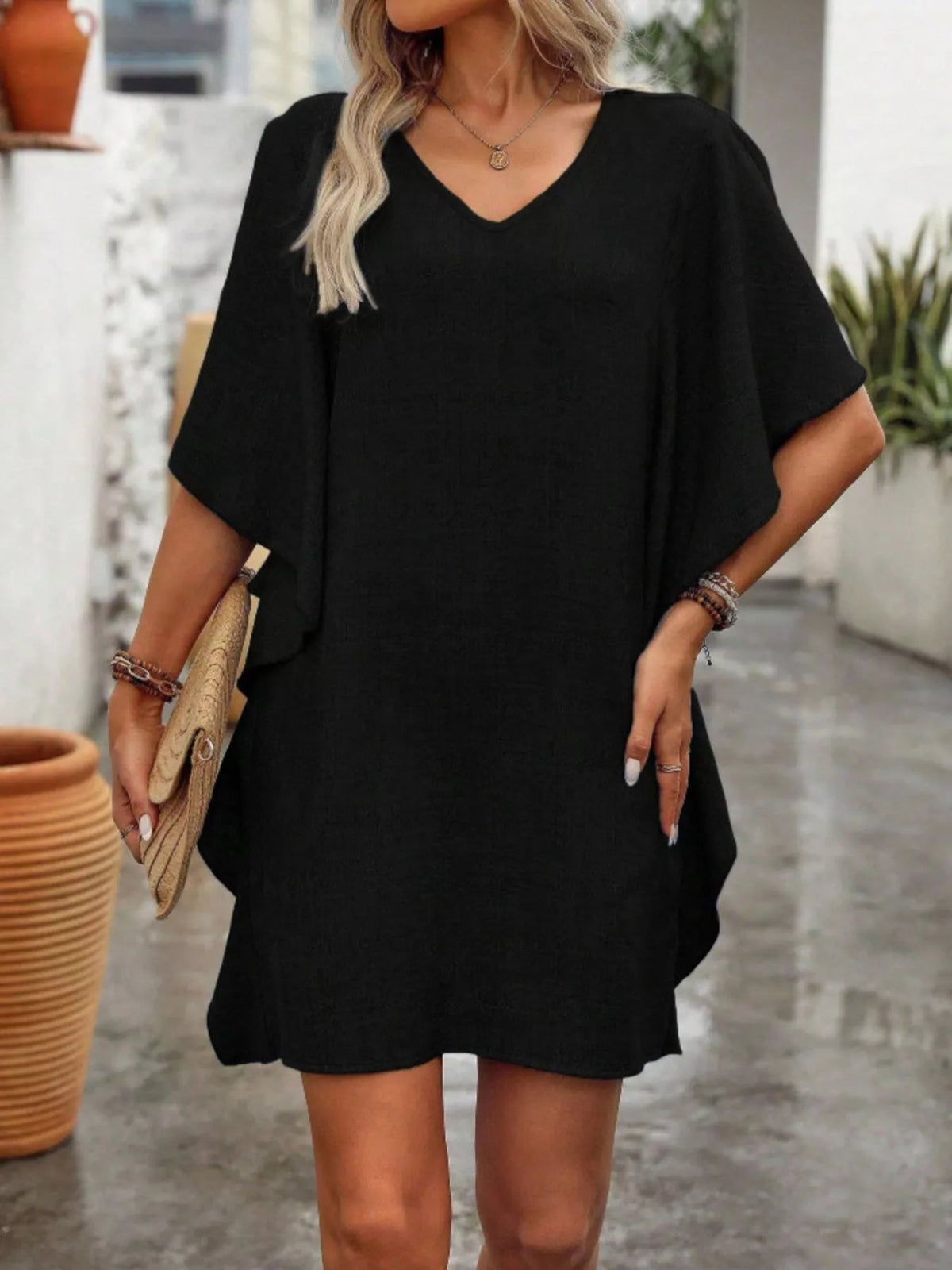 Women’s flowy V-neck casual mini dress with ruffled sleeves by Plush Fashion Hub, shown with a relaxed fit and feminine ruffle details.