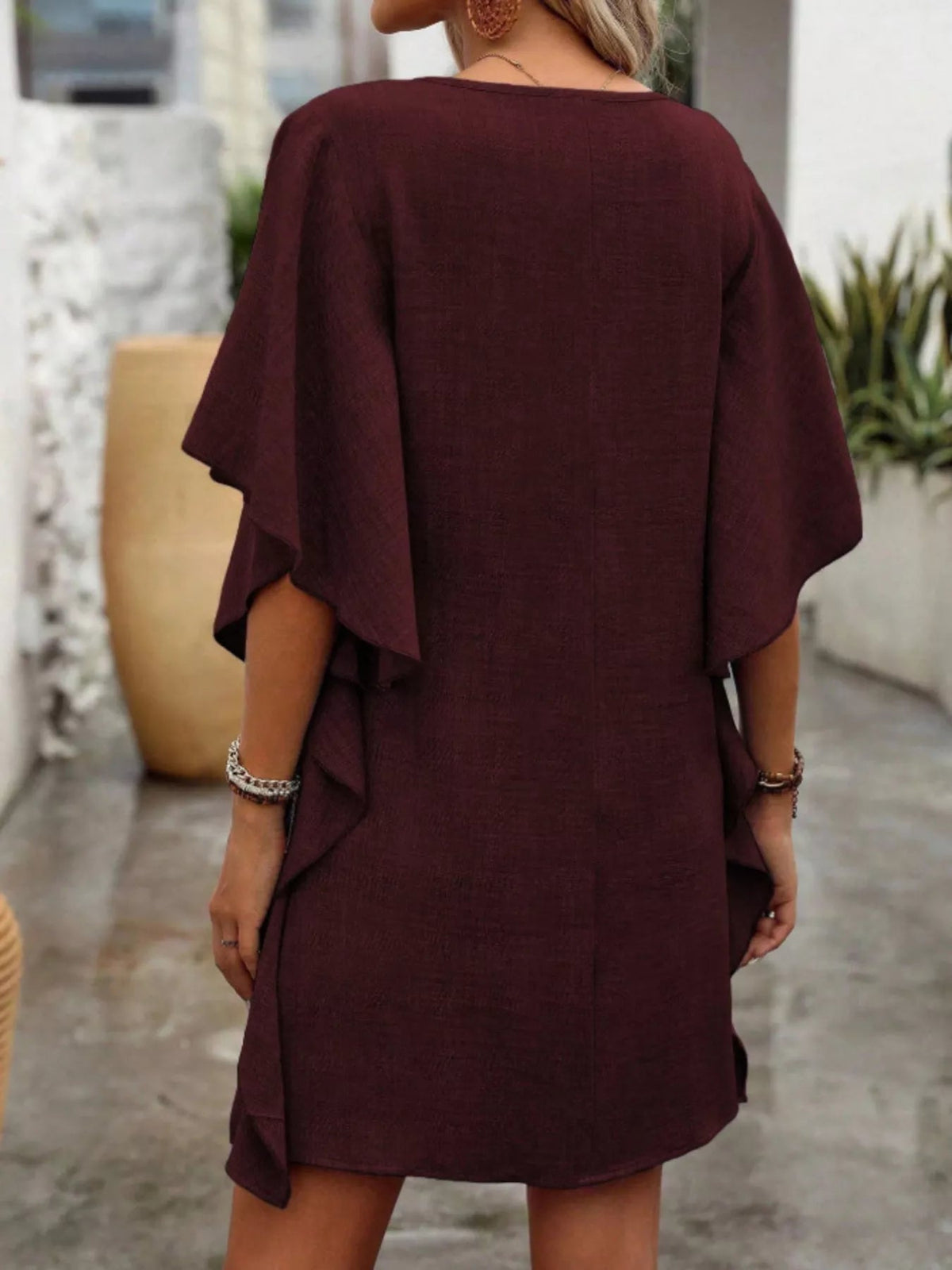 Women’s flowy V-neck casual mini dress with ruffled sleeves from Plush Fashion Hub, featuring a relaxed fit and stylish ruffle details.