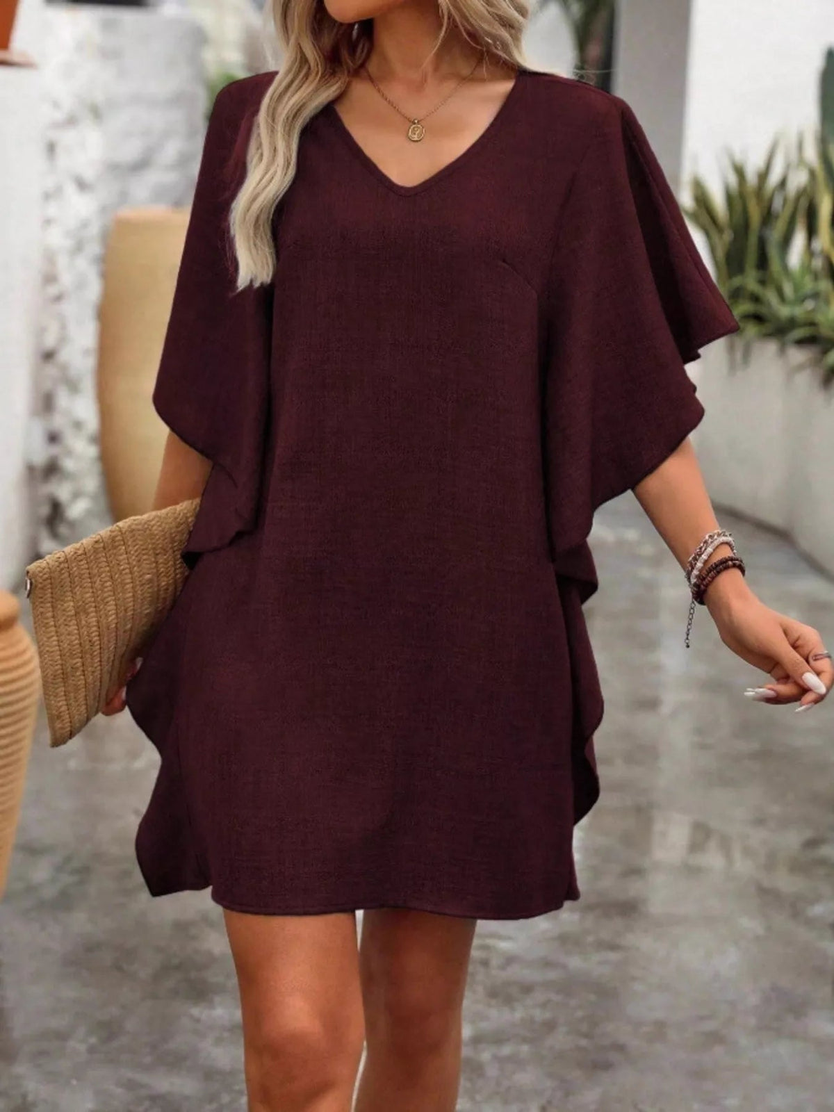 Women’s flowy V-neck casual mini dress with ruffled sleeves by Plush Fashion Hub, shown in a relaxed, stylish fit.