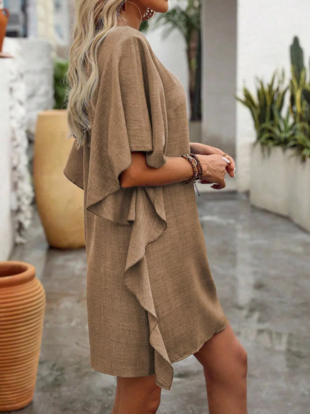Women’s flowy V-neck casual mini dress with ruffled sleeves by Plush Fashion Hub, featuring a relaxed fit and stylish design.