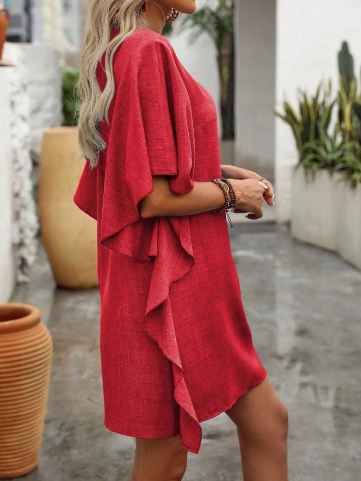 Women’s flowy V-neck casual mini dress with ruffled sleeves by Plush Fashion Hub, featuring a relaxed fit and feminine ruffle details.