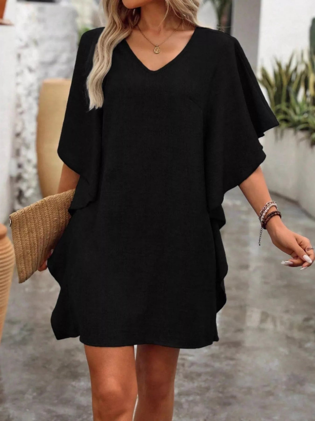 Women’s flowy V-neck casual mini dress with ruffled sleeves by Plush Fashion Hub, shown hanging on a hanger.