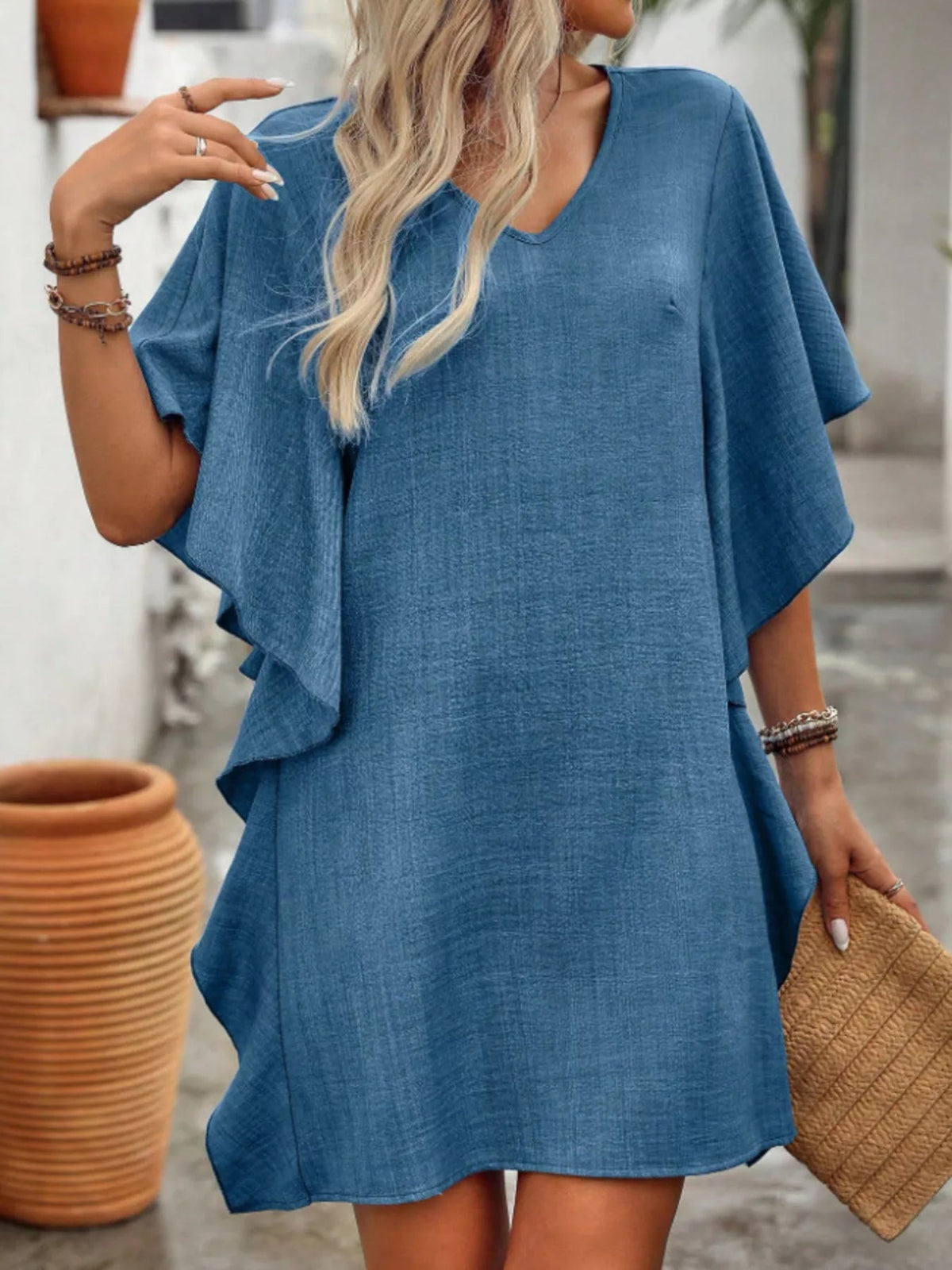 Women’s flowy V-neck casual mini dress with ruffled sleeves from Plush Fashion Hub, showing the lightweight fabric and relaxed fit.