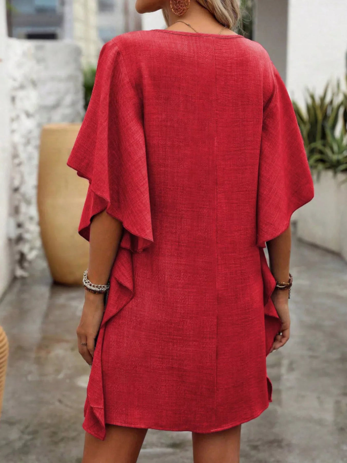 Women’s flowy V-neck casual mini dress with ruffled sleeves by Plush Fashion Hub, shown styled with a relaxed fit and soft fabric.