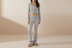 Women's knitted hooded two-piece set with cardigan and high-waisted pants by FitiqueFit, featuring cozy knit fabric and stylish design.