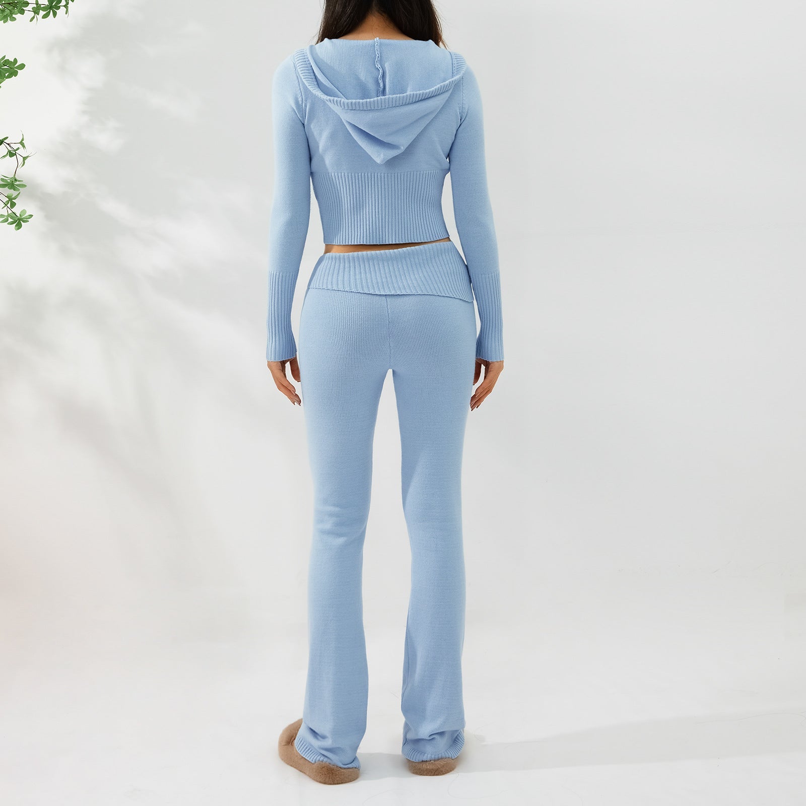 Women’s knitted hooded cardigan and high-waisted pants set by FitiqueFit, featuring a cozy, stylish two-piece knit outfit.