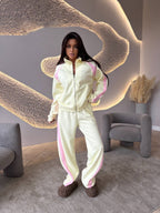 Women’s long-sleeve zip-up jacket and sweatpants two-piece set by FitiqueFit, casual athletic wear, blue color, front view.