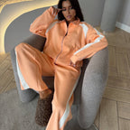 Women’s long-sleeve zip-up jacket and sweatpants two-piece set by FitiqueFit, shown in a comfortable, casual lounge outfit.