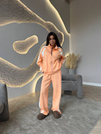 Women’s long-sleeve zip-up jacket and sweatpants two-piece set by FitiqueFit, featuring casual comfortable loungewear style.