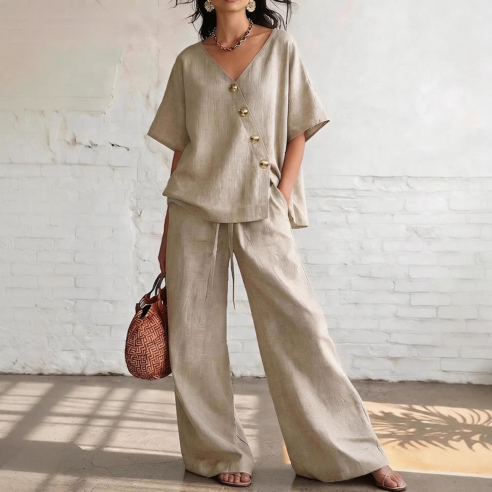 Women's loose cotton-linen V-neck top and wide-leg pants set, casualwear by FitiqueFit, displayed on a model.
