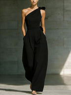 Women's loose sleeveless off-shoulder wide-leg jumpsuit with belt by FitiqueFit, casualwear style, shown on a model.