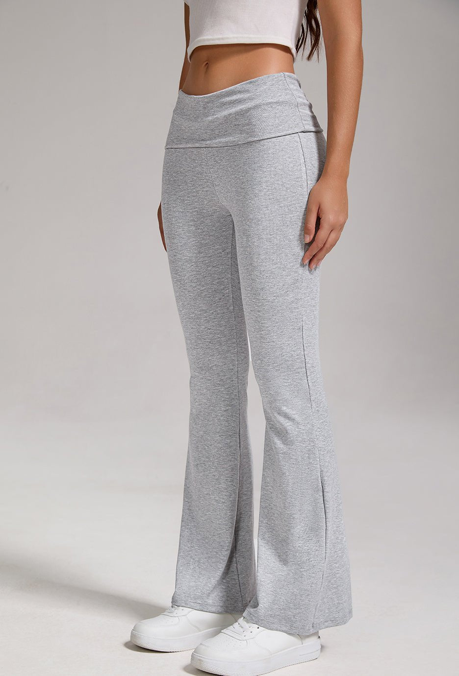 Women's low-waisted flared pants with folded waist and wide-leg style, casualwear by FitiqueFit, shown in natural fabric and fit.