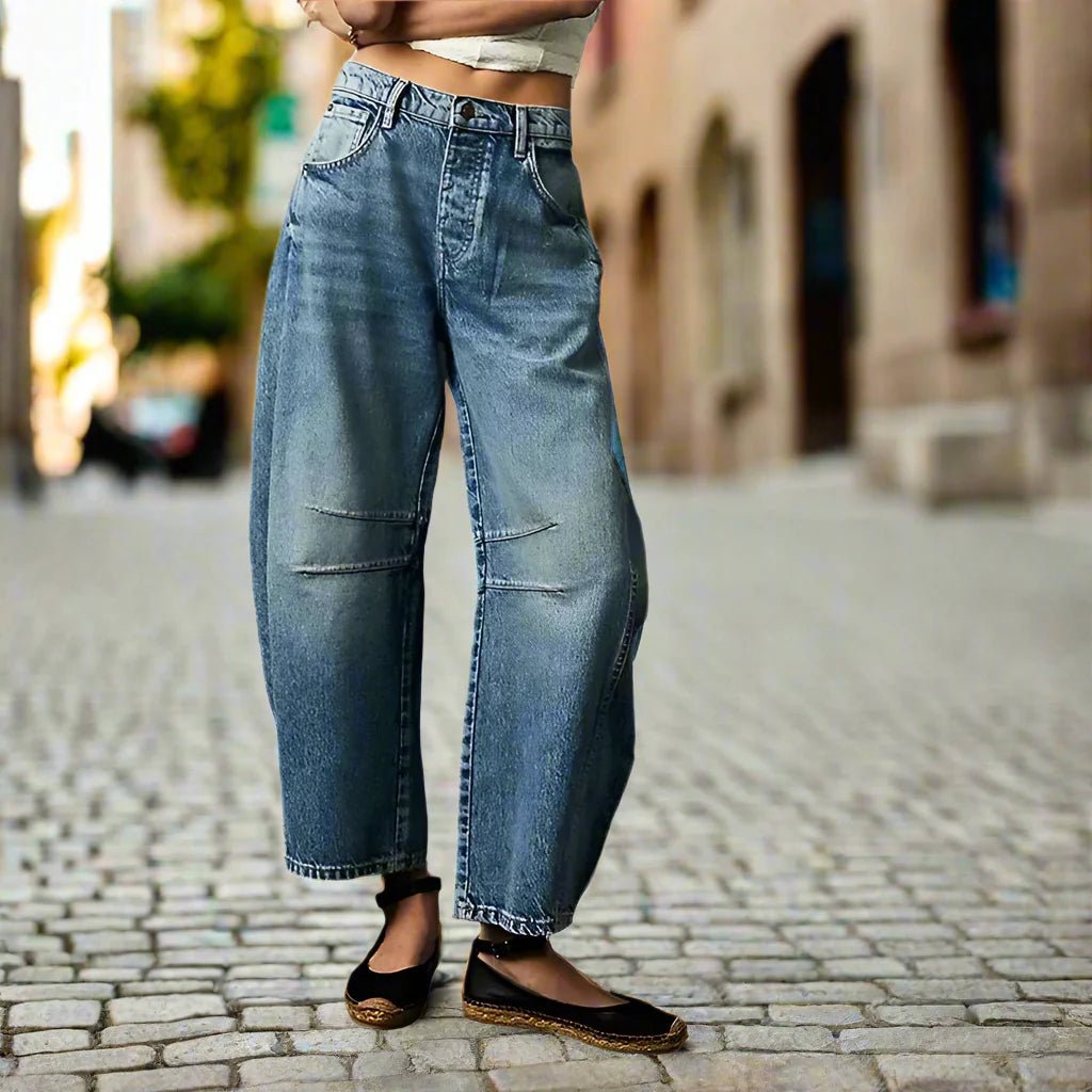 Women’s mid-rise wide-leg jeans by FitiqueFit, casual wear with a relaxed fit, shown on a model with hands in pockets.