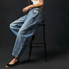 Women’s mid-rise wide-leg jeans by FitiqueFit, casualwear with a relaxed fit, shown on a model with hands in pockets.