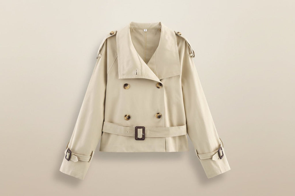 Women's short trench coat with notch collar and belt buckle detail, stylish FitiqueFit jacket perfect for layered outfits.