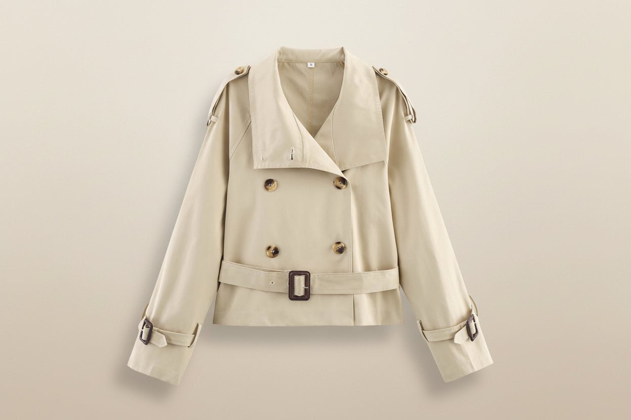 Women's short trench coat with notch collar and belt buckle detail, stylish FitiqueFit jacket perfect for layered outfits.