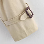 Women's short trench coat with notch collar and belt buckle detail, stylish FitiqueFit jacket for a chic, polished look.