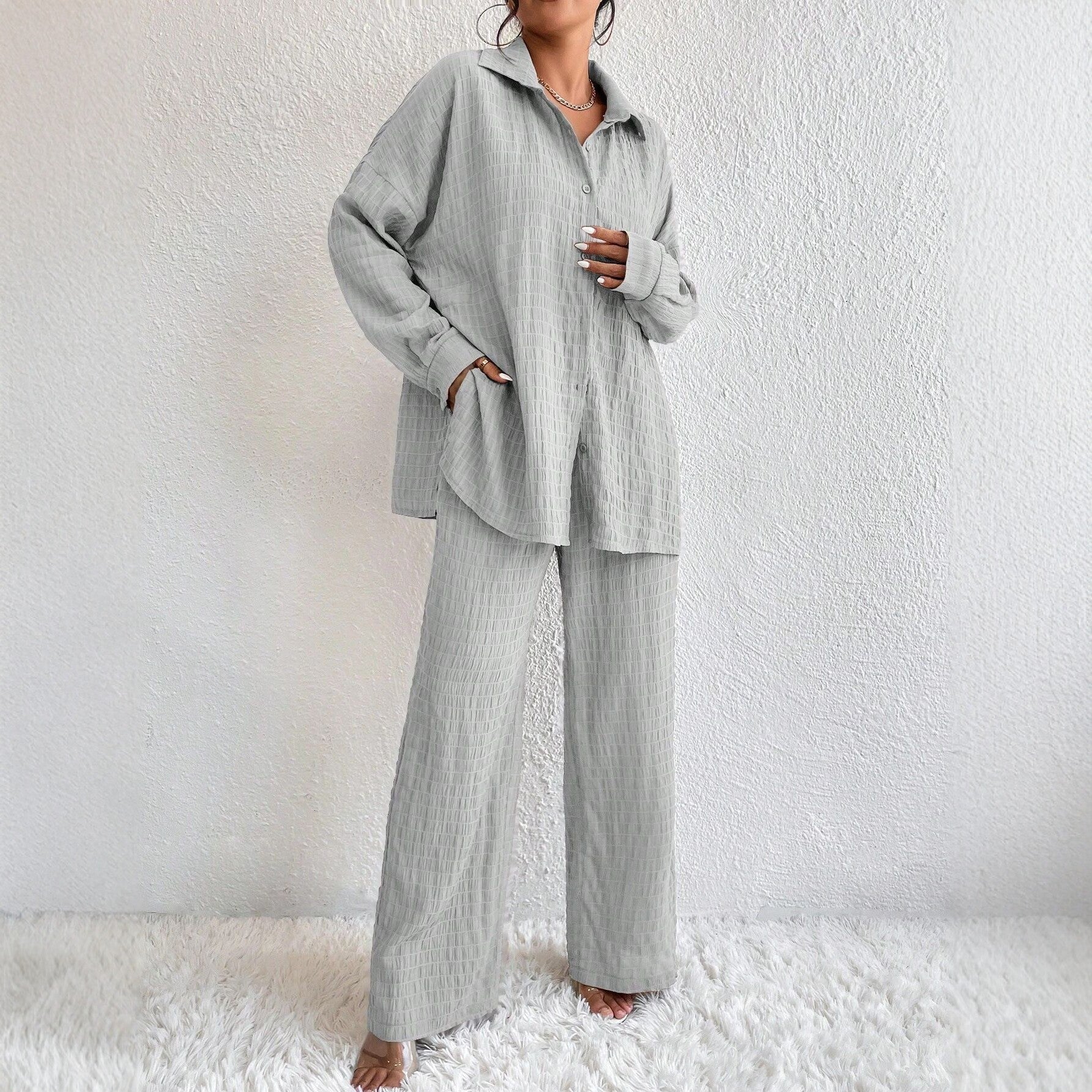 Women's pleated long sleeve lapel two-piece set by FitiqueFit with loose top and matching pants, casualwear ensemble.