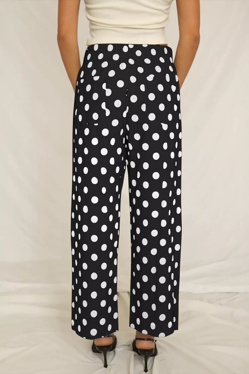 Women's polka dot straight-leg pants with pockets from Trendsi, featuring a stylish fit and classic pattern.