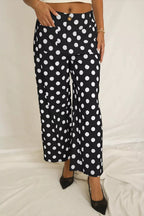 Women's polka dot straight leg pants with pockets by Trendsi, featuring a comfortable fit and classic pattern.