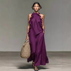 Women's ruffled halterneck sleeveless open-back maxi dress by FitiqueFit, perfect for resort casualwear, with flowing fabric and elegant design.
