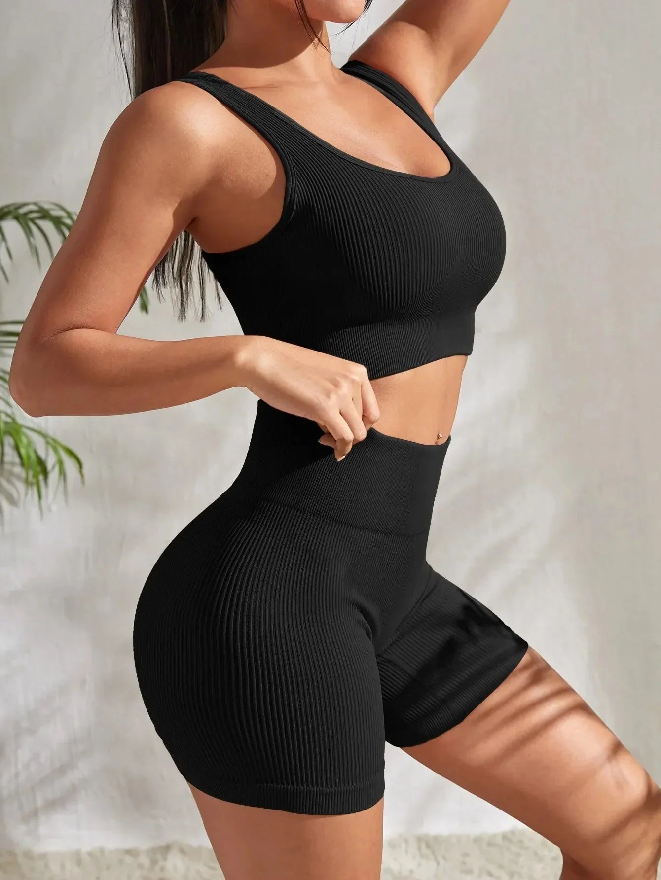 Women's seamless ribbed yoga set by FitiqueFit, featuring a fitted top and high-waisted leggings for activewear.