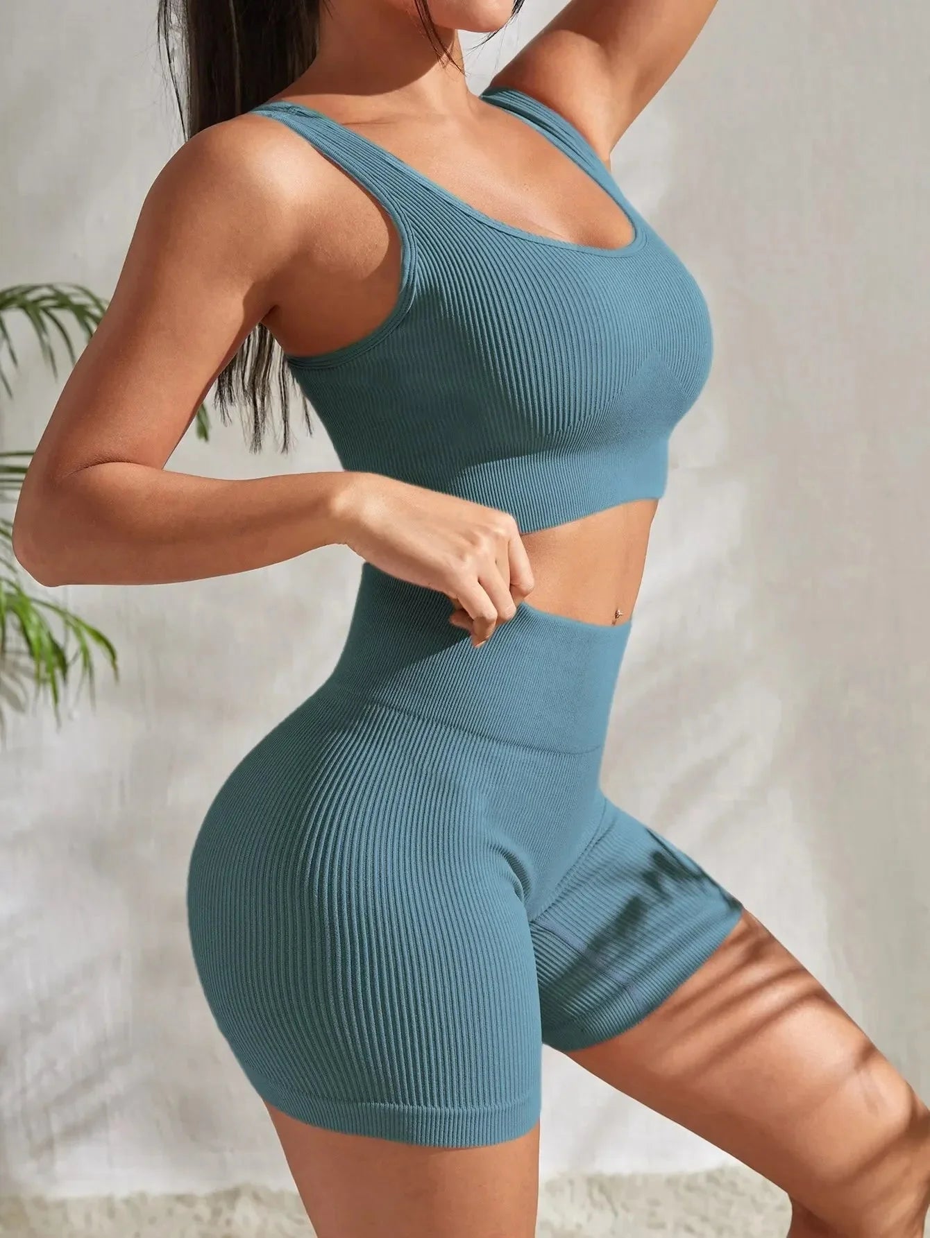 Women’s seamless ribbed yoga set by FitiqueFit, featuring a fitted tank top and high-waisted leggings in soft, stretchy fabric.