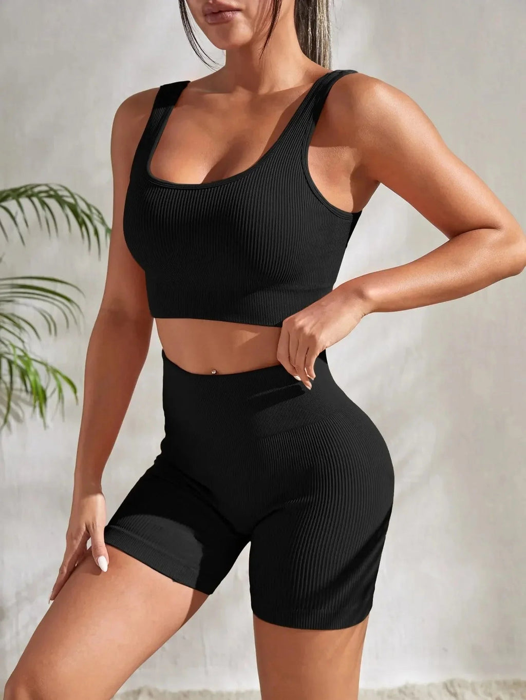 Women's seamless ribbed yoga set by FitiqueFit featuring a fitted top and high-waisted leggings for activewear.