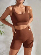 Women’s seamless ribbed yoga set by FitiqueFit, featuring a fitted tank top and high-waisted leggings in soft, stretchy fabric.