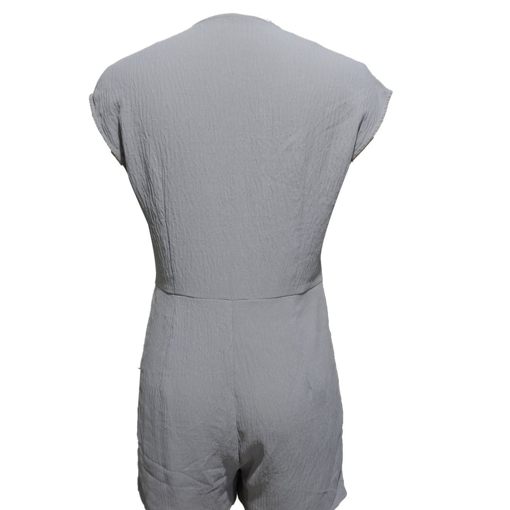 Women’s short button-front jumpsuit with V-neck and patchwork design, casualwear by FitiqueFit, shown on a model.