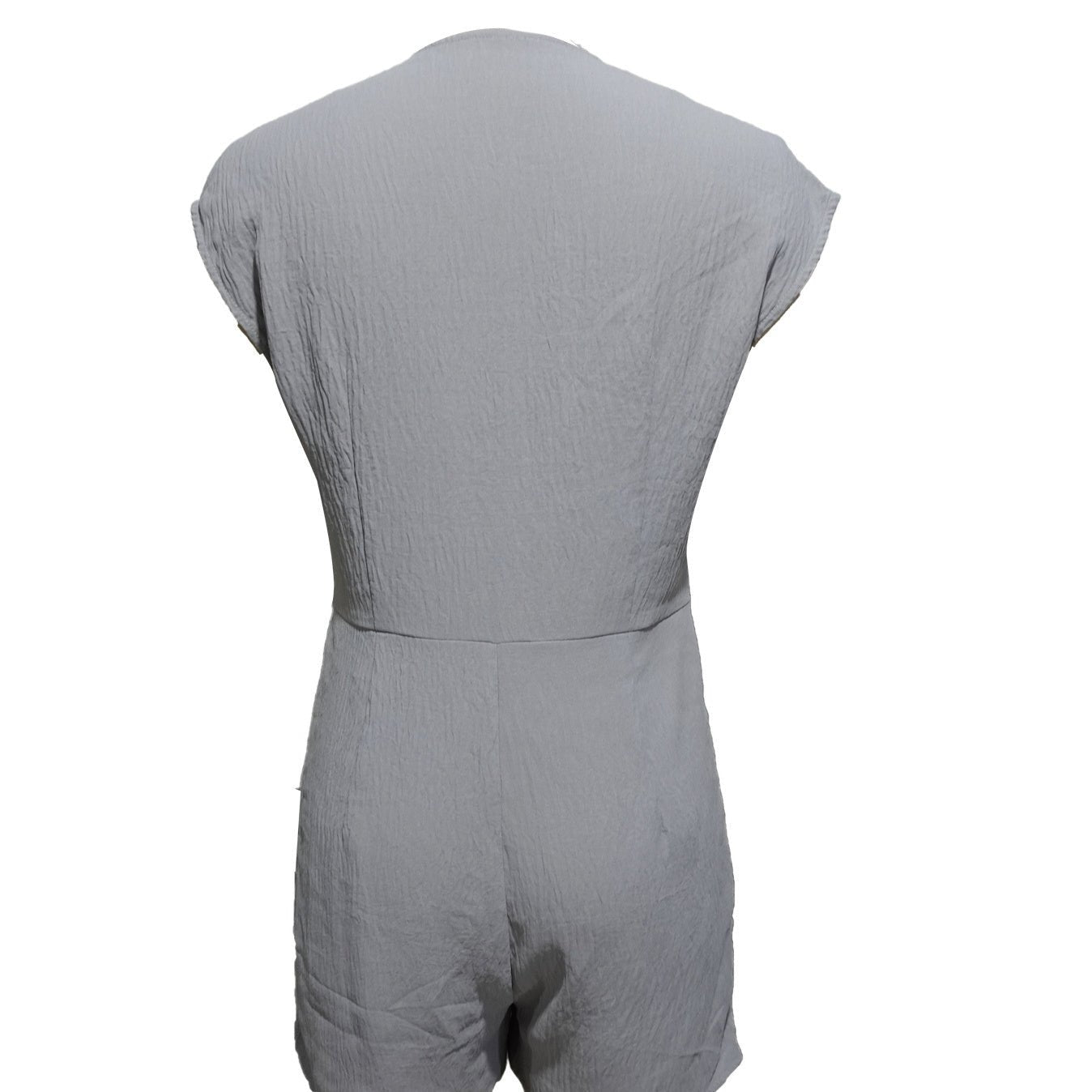 Women’s short button-front jumpsuit with V-neck and patchwork design, casualwear by FitiqueFit, shown on a model.