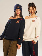 Women’s slanted shoulder embroidered long-sleeve top by FitiqueFit, featuring intricate embroidery and casual chic design.