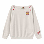 Women’s slanted shoulder embroidered long-sleeve top from FitiqueFit, featuring casualwear style with intricate embroidery details.