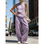 Women's sleeveless cardigan top and matching pants two-piece casualwear set by FitiqueFit, shown laid out flat.