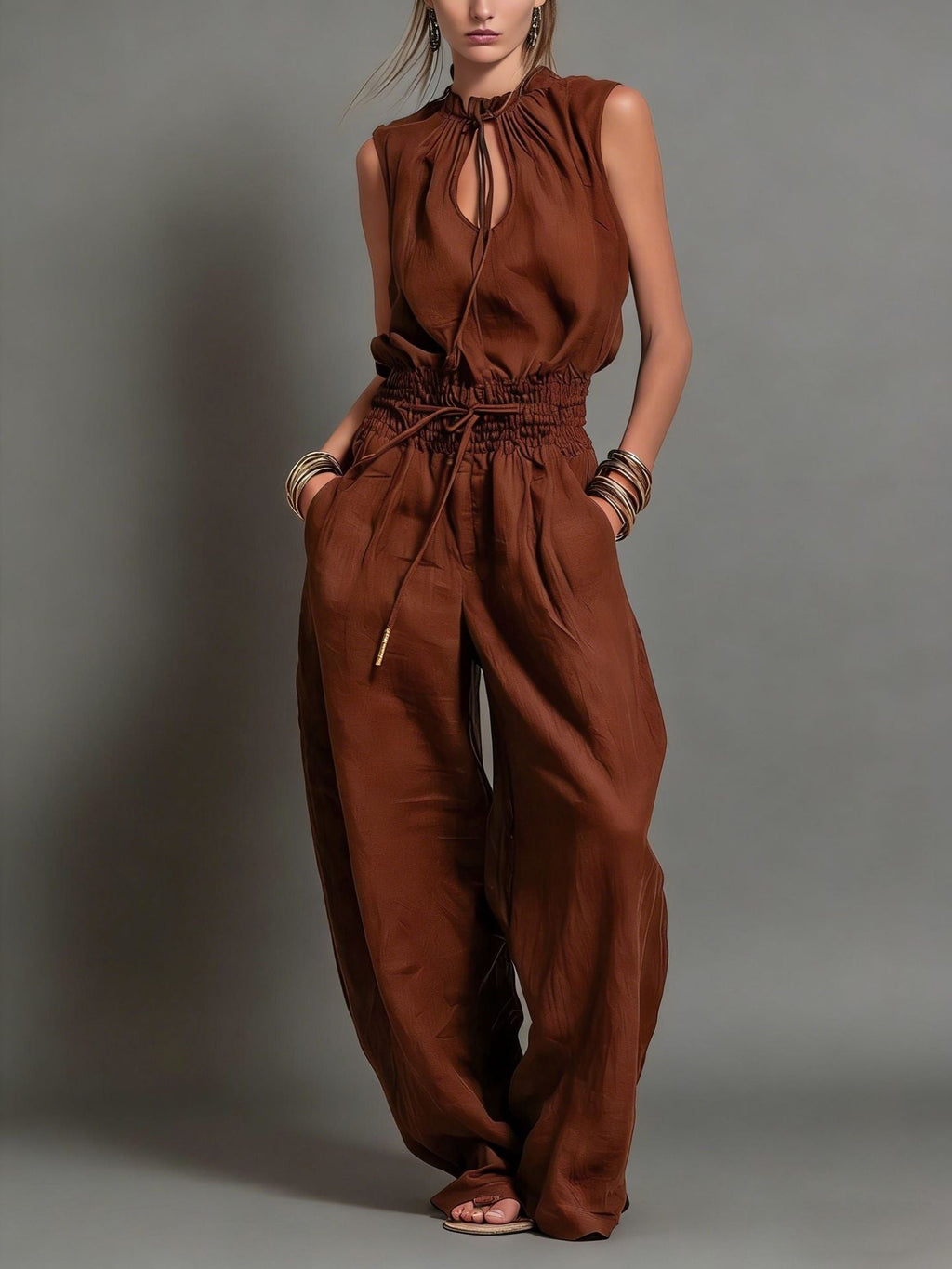 Women's sleeveless high-waist wide-leg pleated jumpsuit by FitiqueFit, casualwear with flowing fabric and a stylish cut.