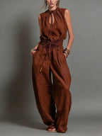 Women's sleeveless high-waist wide-leg pleated jumpsuit by FitiqueFit, casualwear with flowing fabric and a stylish cut.