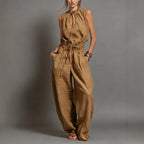 Women's sleeveless high-waist wide-leg pleated jumpsuit by FitiqueFit, casualwear, shown in a neutral pose highlighting the style and fit.