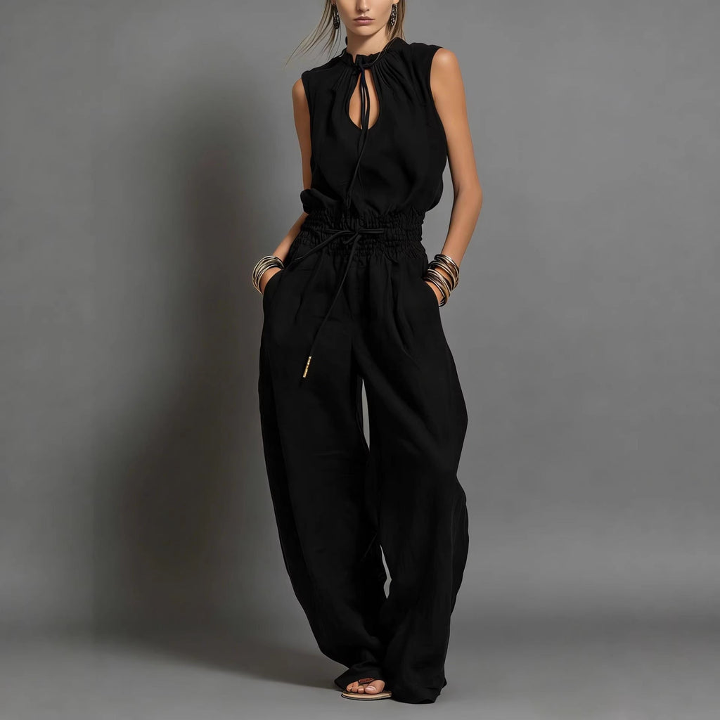 Women's sleeveless high-waist wide-leg pleated jumpsuit by FitiqueFit, featuring a casual, stylish design and flowing fabric.