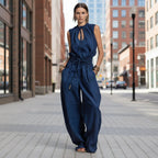 Women's sleeveless high-waist wide-leg pleated jumpsuit by FitiqueFit, displayed flat with flowing fabric and stylish design.